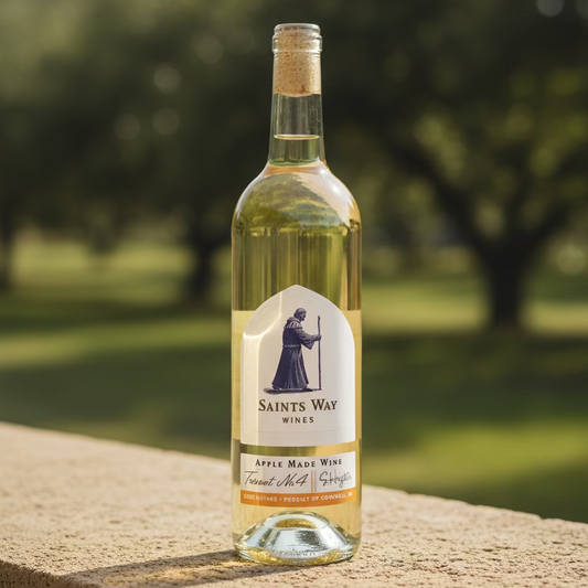 A bottle of Saints Way Wines apple wine, featuring a white label with a blue saint illustration 